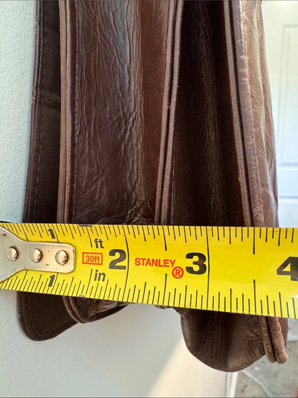 Wilson’s Leather chocolate brown messenger bag with webbed adjustable strap.